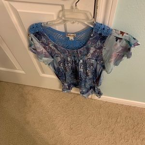 a blue pattern top with low neck lace style